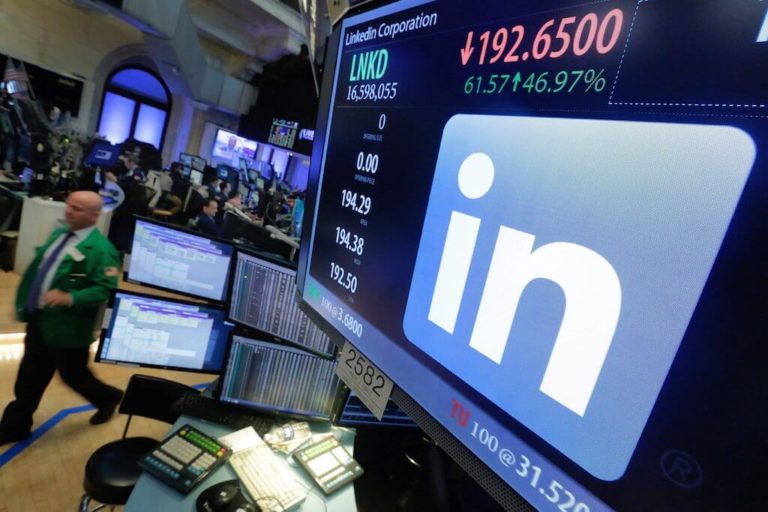 In this Monday, June 13, 2016, file photo, the LinkedIn logo appears on a screen at the post where it trades on the floor of the New York Stock Exchange. Microsoft will break out LinkedIn revenue when it reports its quarterly earnings Wednesday, Jan. 31, 2018. (AP Photo/Richard Drew, File)