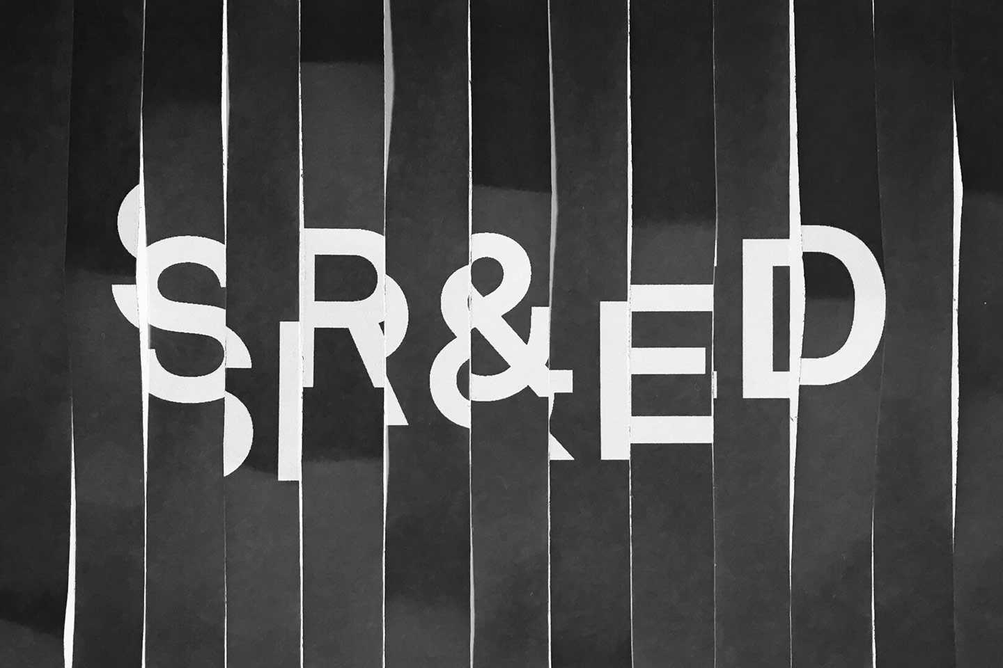 A black-and-white illustration shows strips of shredded paper hanging vertically with the word “SR&ED” printed in black.