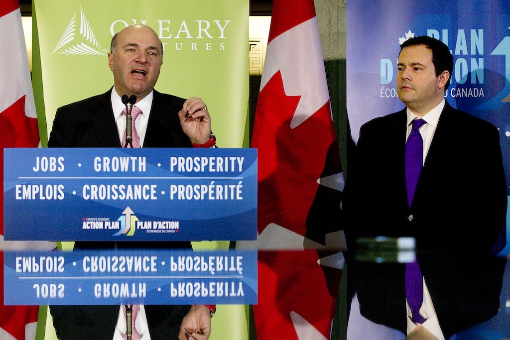 Investor Kevin O'Leary and then-immigration minister Jason Kenney are reflected in during a press conference to launch the Start-up Visa Program in April 2013.
