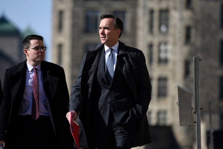 Finance Minister Bill Morneau arrives for a press conference on economic support for Canadians impacted by COVID-19 at West Block on Parliament Hill in March 2020.