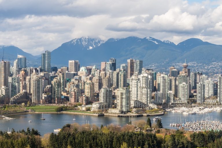 Buildings stretch across Vancouver’s skyline, framed by snow-capped peaks.