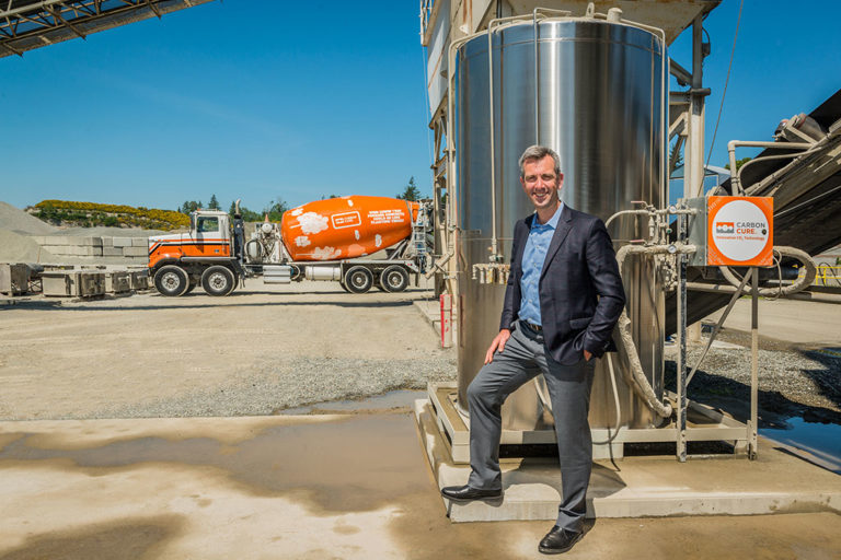 CarbonCure CEO Rob Niven with the company’s technology and a truck that delivers concrete mixed using it.