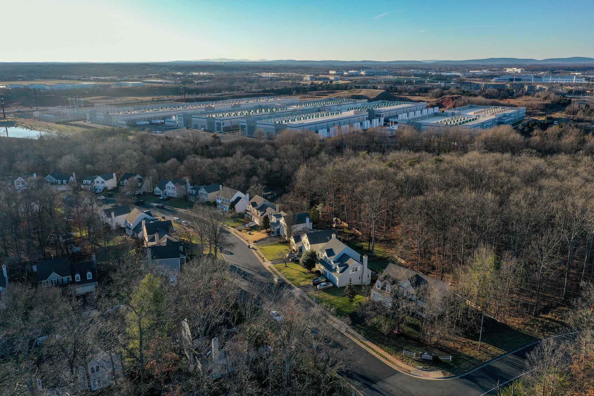 An aerial look at vast, warehouse-like buildings in a leafy suburban area of Virginia.