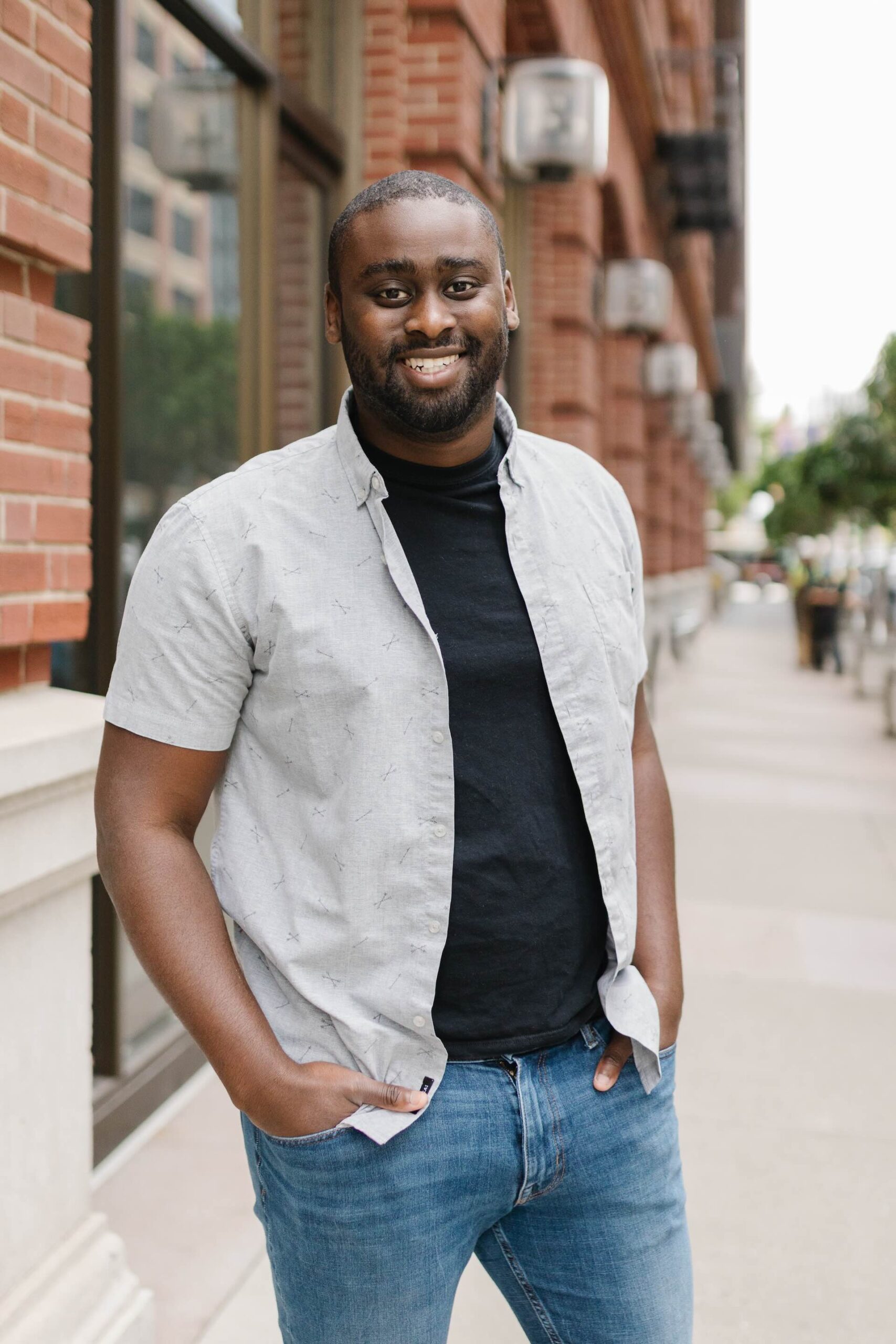 A photo of Forethought CEO Deon Nicholas, wearing a black T-shirt with a white shirt over it, and denim jeans.