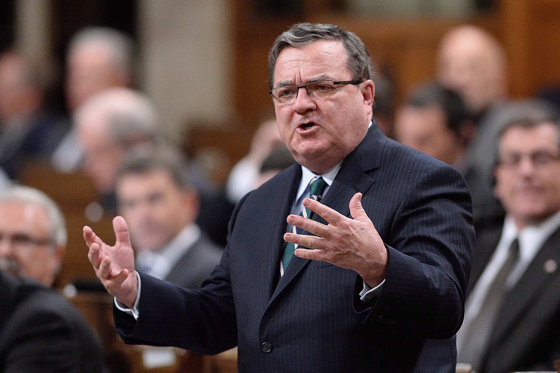 The late Jim Flaherty is pictured here, as finance minister, with his arms outstretched in the House of Commons.