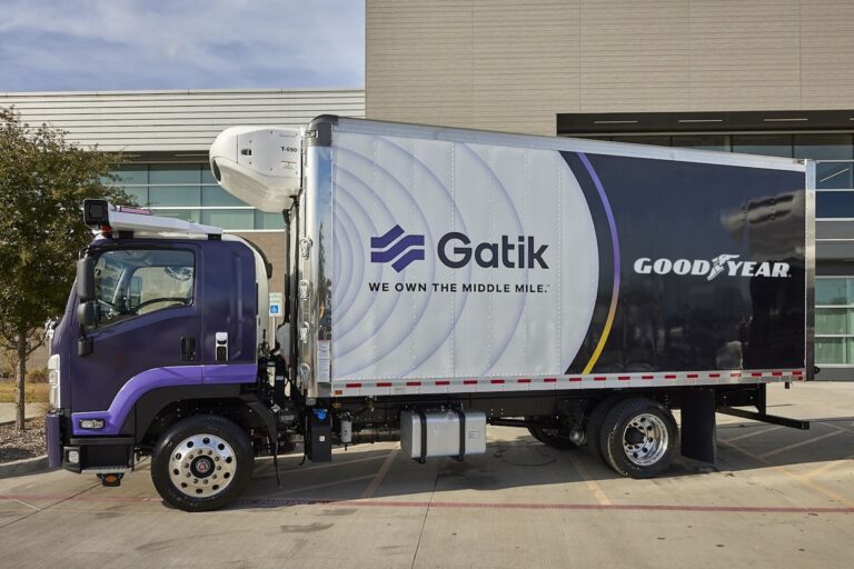 A side view of a purple transport truck with the Gatik logo and the slogan “We Own The Middle Mile” on its side.