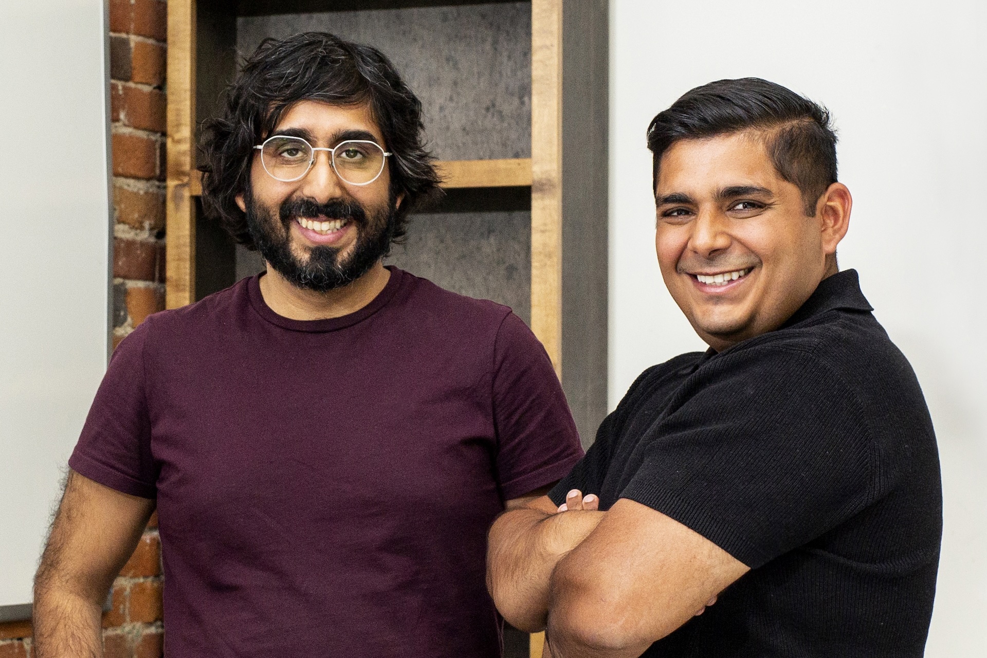 PocketHealth co-founder Harsh Nayyar smiling and standing next to his brother and co-founder Rishi Nayyar on the right with his arms crossed.