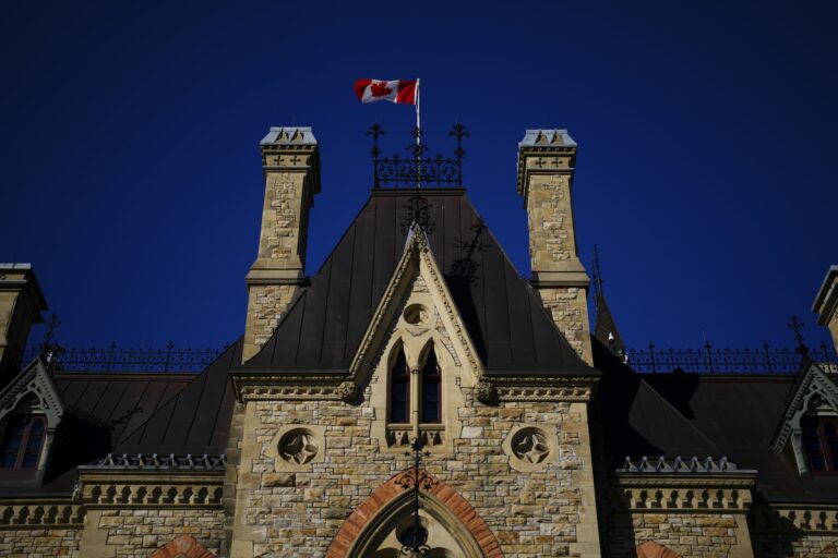 A Canada flag flies on top of Parliament Hill. 