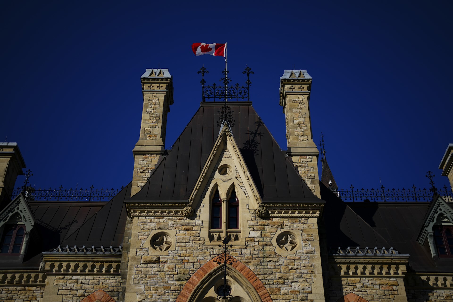 A Canada flag flies on top of Parliament Hill. 