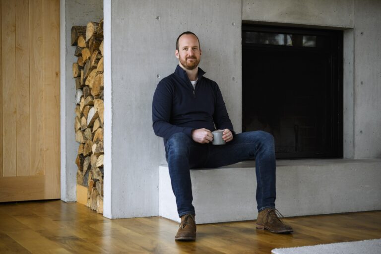 Ted Livingston, the former CEO of Kik, sitting and holding a coffee mug with both his hands.