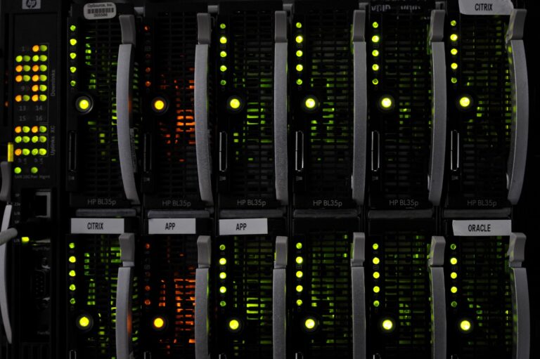 Black electronic devices with green blinking lights, stacked in two rows and six columns.