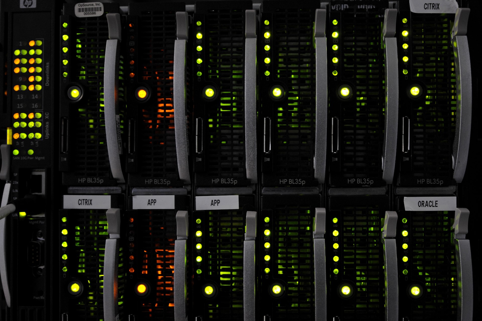Black electronic devices with green blinking lights, stacked in two rows and six columns.
