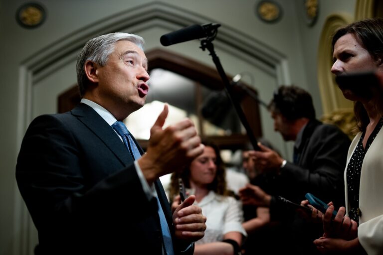 Minister of Innovation, Science and Industry Francois-Philippe Champagne speaking as a bunch of people hold microphones in their hands.