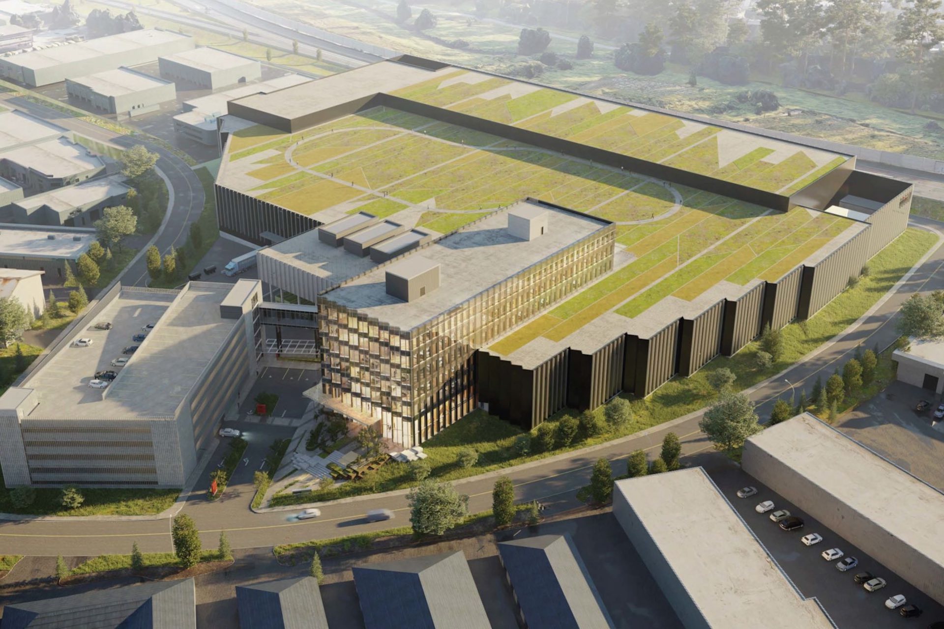 An overhead digital mockup of a sprawling factory complex with a rectangular steel-and-glass office complex built into the middle of it.