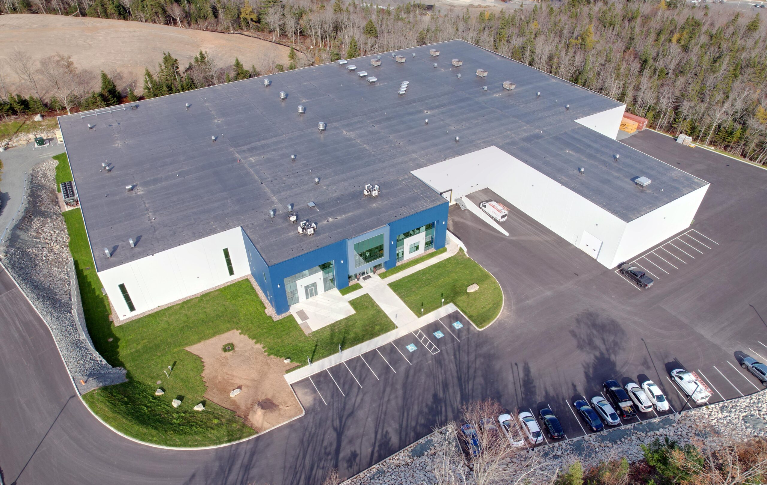 An overhead view of an Oberland facility with a gray roof and white-and-blue exterior.