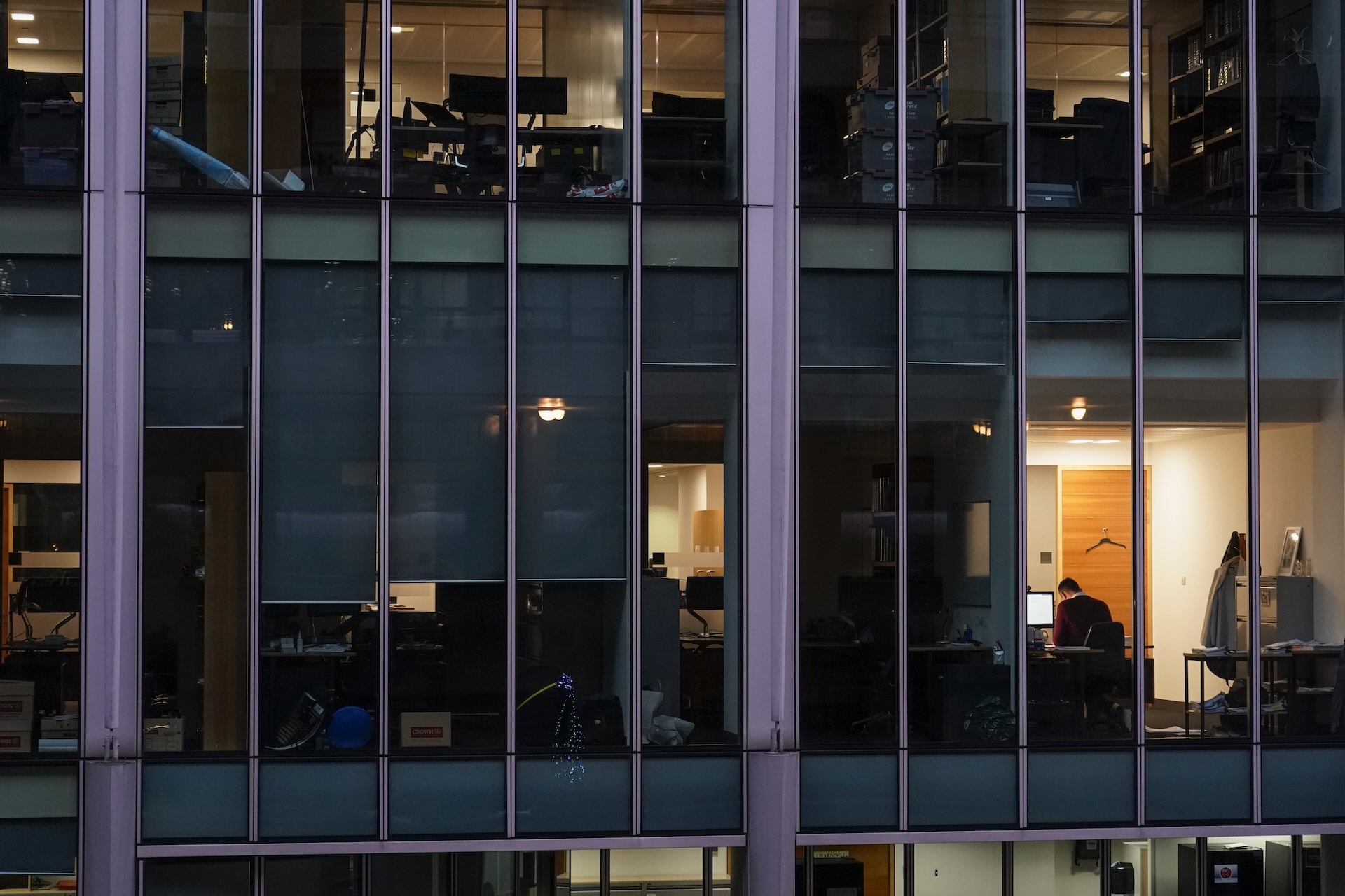 Employees working in a glass office building.