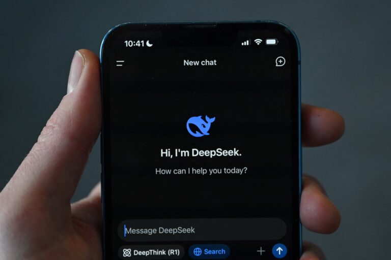 The DeepSeek app on a smartphone. The screen says "Hi, I'm DeepSeek. How can I help you today?"