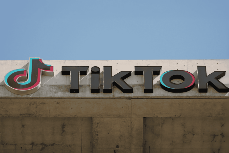 A close-up of the TikTok logo on the side of a concrete structure.