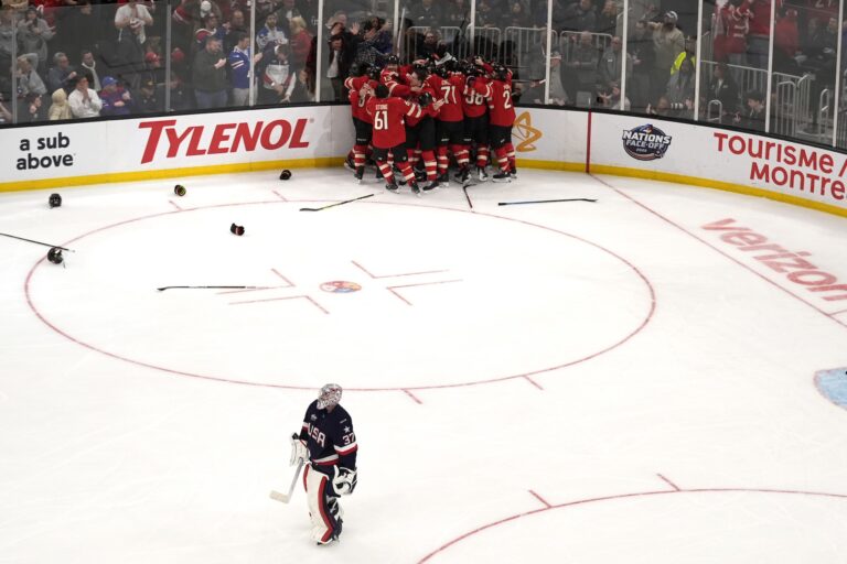 Team U.S.A. goaltender Connor Hellebuyck skates away as Canadian players celebrate Connor McDavid's tournament-winning overtime goal at the 4 Nations Face-Off in Boston, on Feb. 20, 2025.