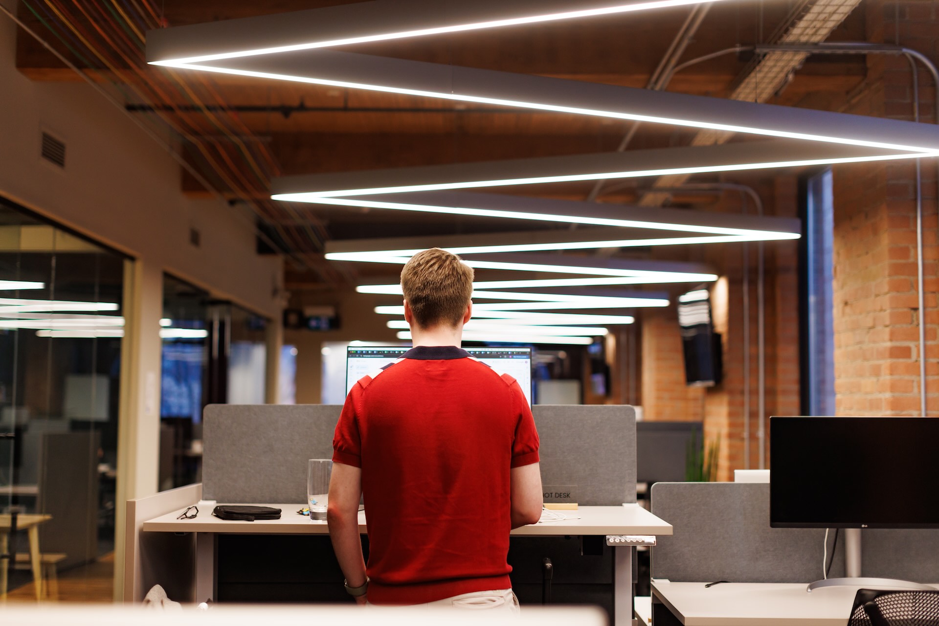 A Cohere employee stands at a desk at the company’s office.