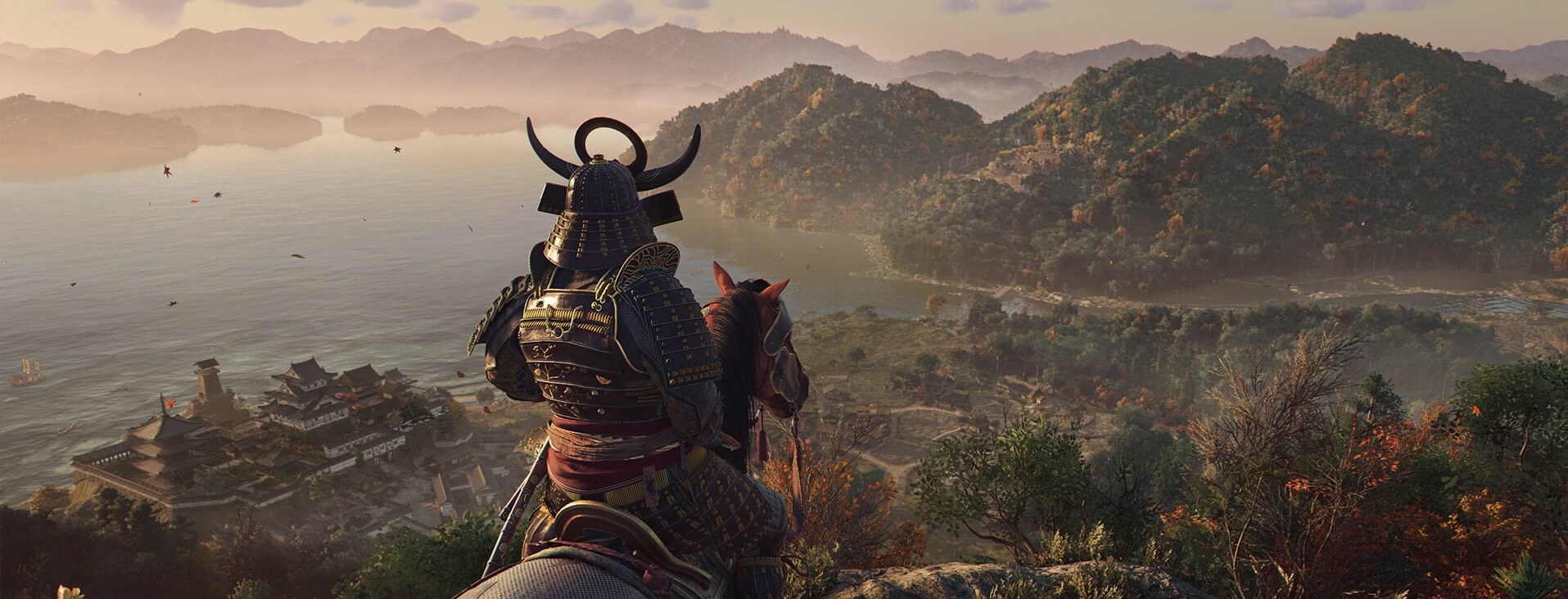 View from behind of a samurai on horseback looking out over a fortress on a lake, with forests and hills in the near view and mountains in the distance.