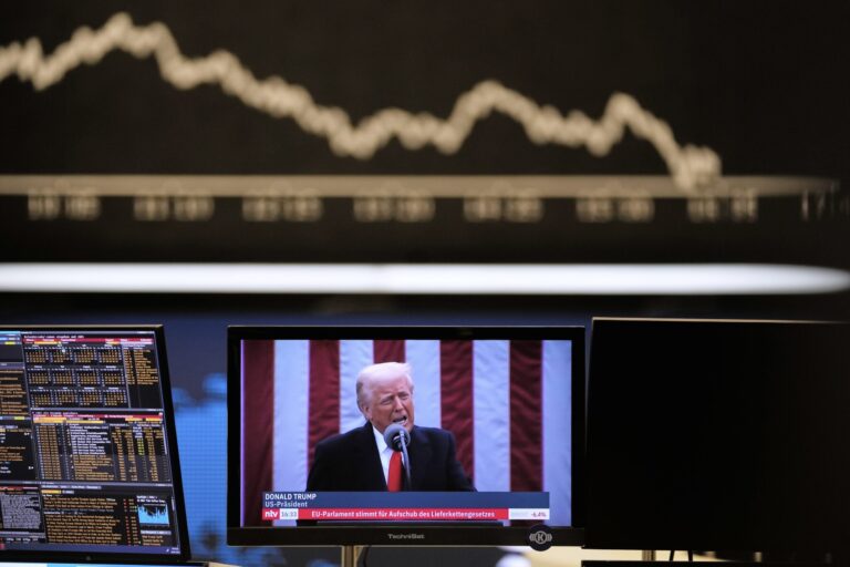 A screen of president Donald Trump appears in front of a stock chart and a chart containing key headlines.