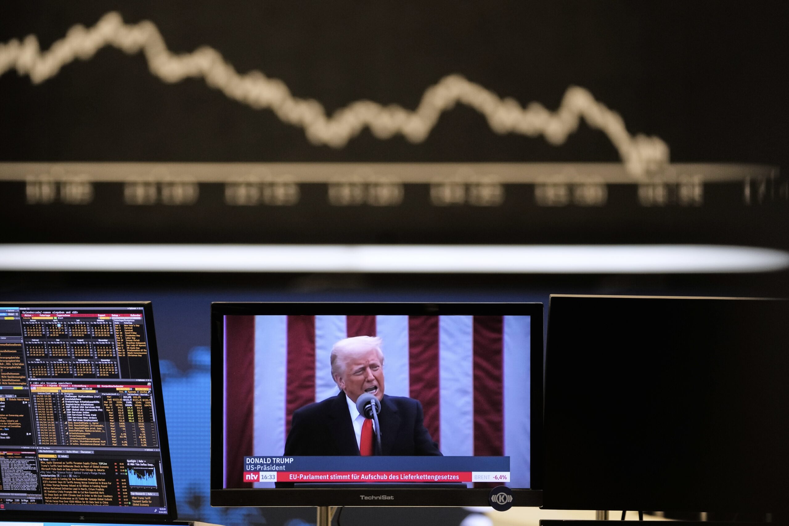 A screen of president Donald Trump appears in front of a stock chart and a chart containing key headlines.
