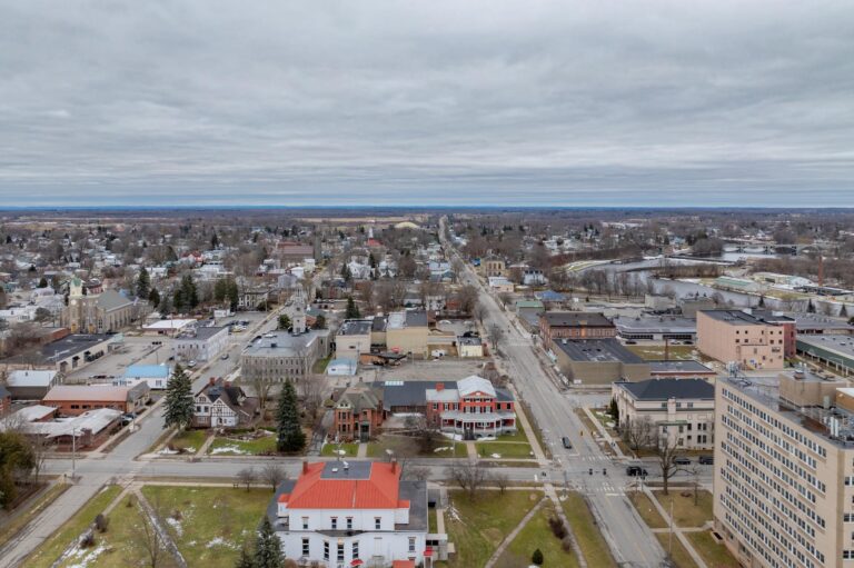 An aerial shot of an upstate New York city against a flat, grey sky.
