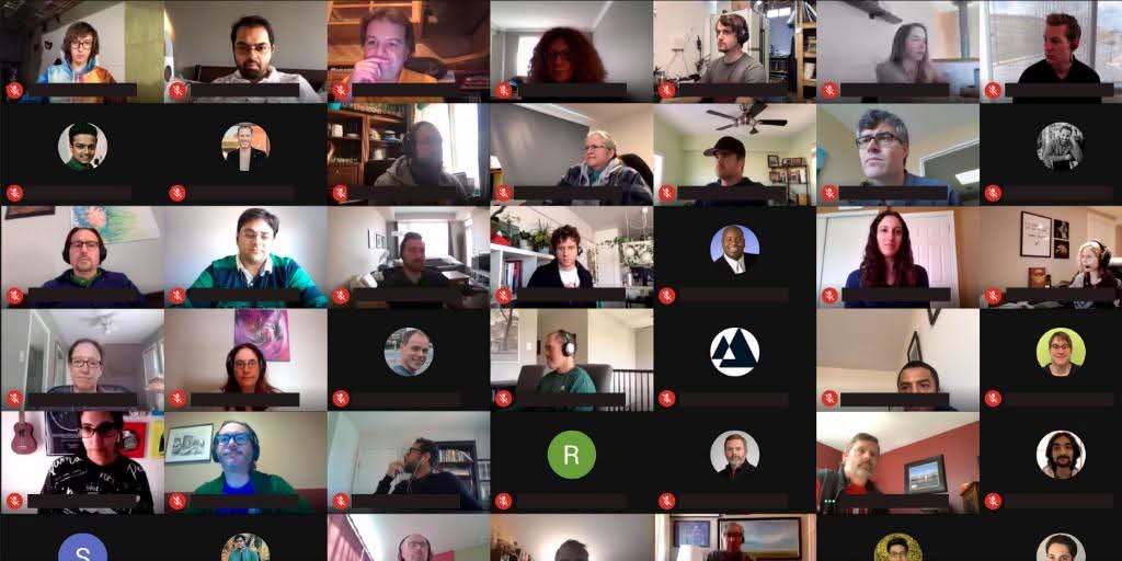 A screenshot of a video call where dozens of employees are seen in small boxes. Most have their microphones muted and are at home.