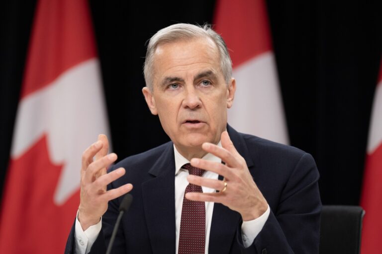Prime Minister Mark Carney gesticulates as he responds to a question from the media during a news conference, in Ottawa, Friday, May 2, 2025.