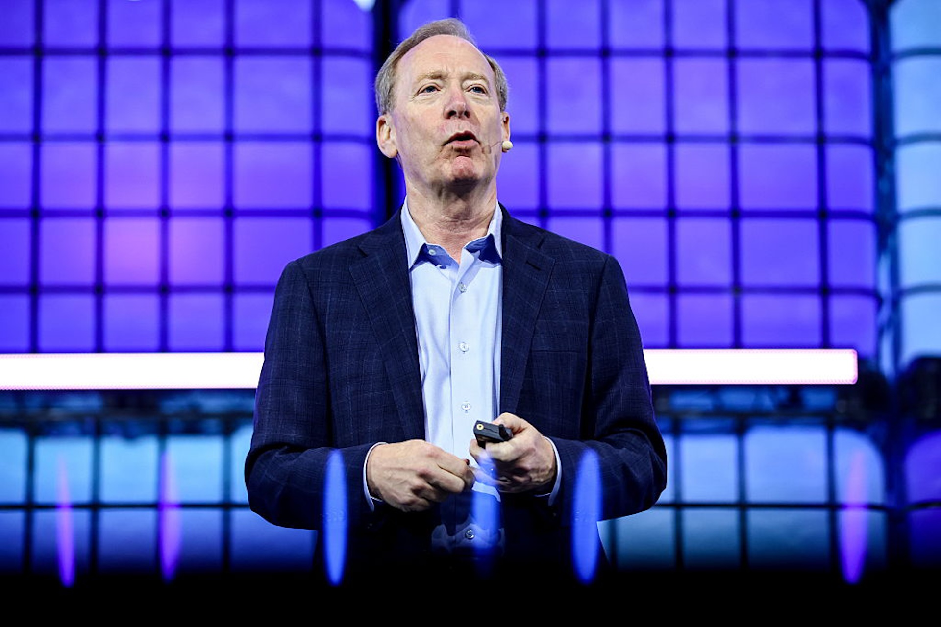 Brad Smith, vice-chair and president of Microsoft, stands on centre stage during day one of Web Summit Vancouver 2025 at the Vancouver Convention Centre.