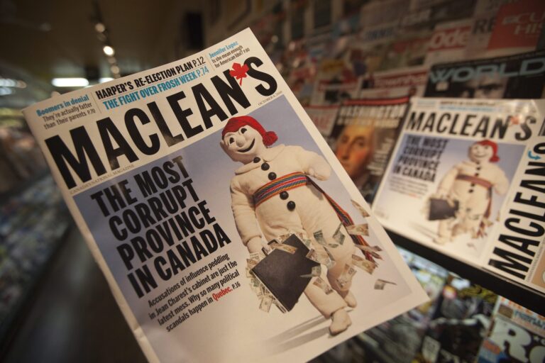 An issue of Maclean's magazine is held up in a shop