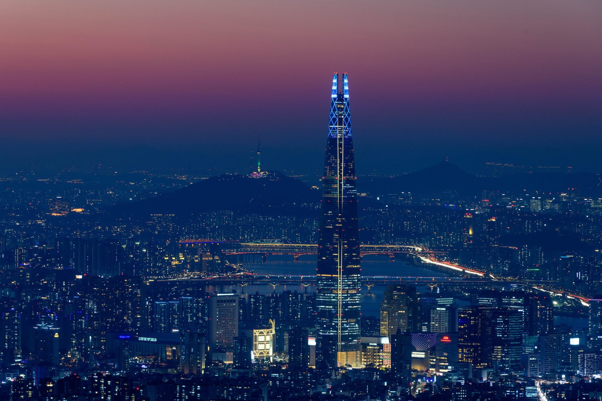 Picture of Seoul showing the Hangang River and buildings between the city's iconic tourist attractions, 123-storey skyscraper Lotte Tower and Namsan Tower