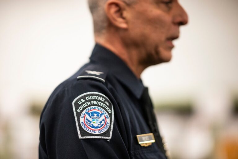 A close-up of a U.S. Customs and Border Protection badge on the shoulder of a senior agent.