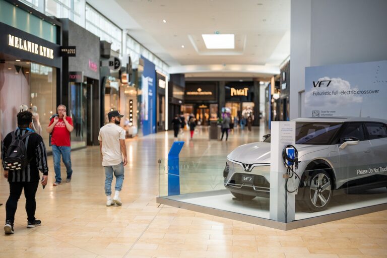 Shoppers walk past one of three Vinfast electric vehicles at Yorkdale Shopping Centre in Toronto on May 25, 2022.