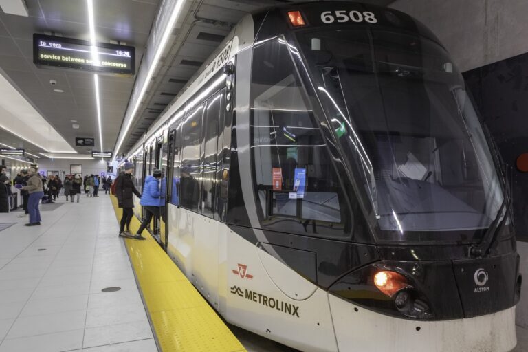 Picture of people boarding a TTC light-rail train from a passenger platform.