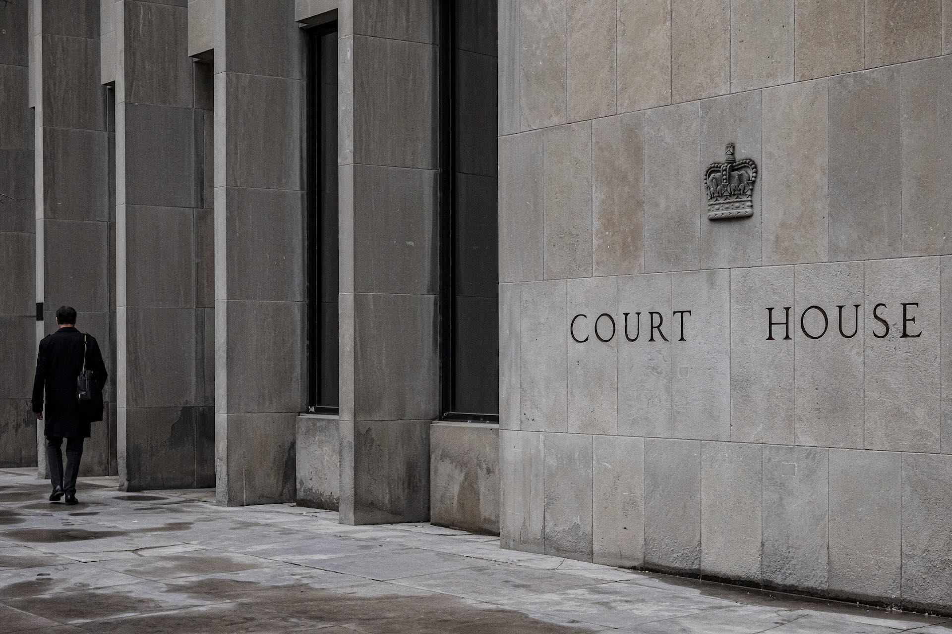 The words "Court House" appear on the side of a grey stone building.