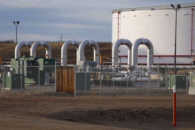 A shot of a storage tank and an array of equipment at a pipeline station in Alberta.