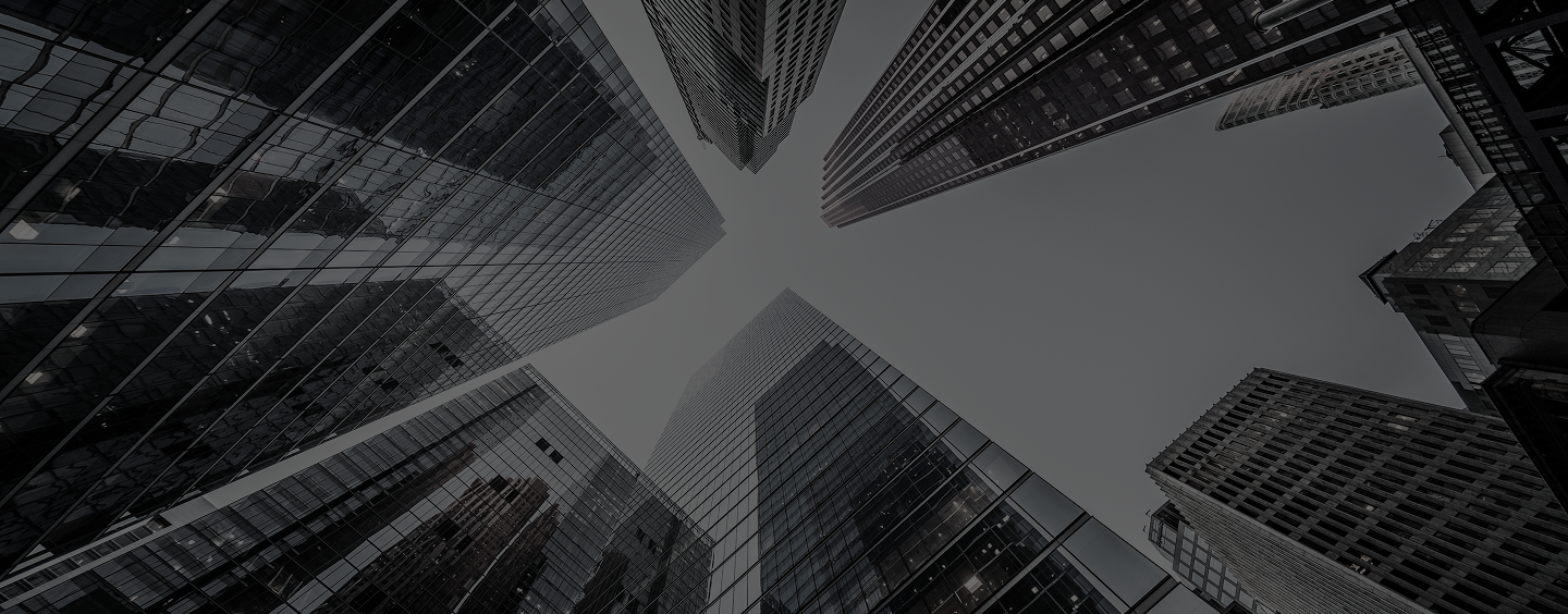 A vantage point of looking up at skyscrapers while standing on the ground
