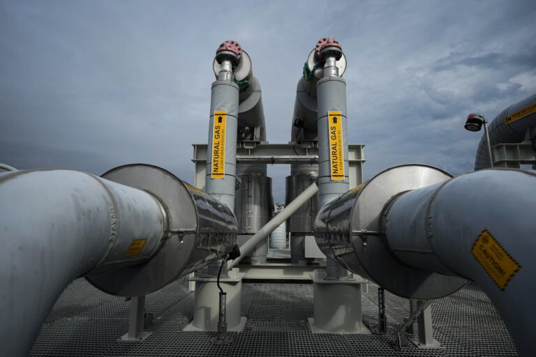 An image of a natural gas terminal against a grey sky.