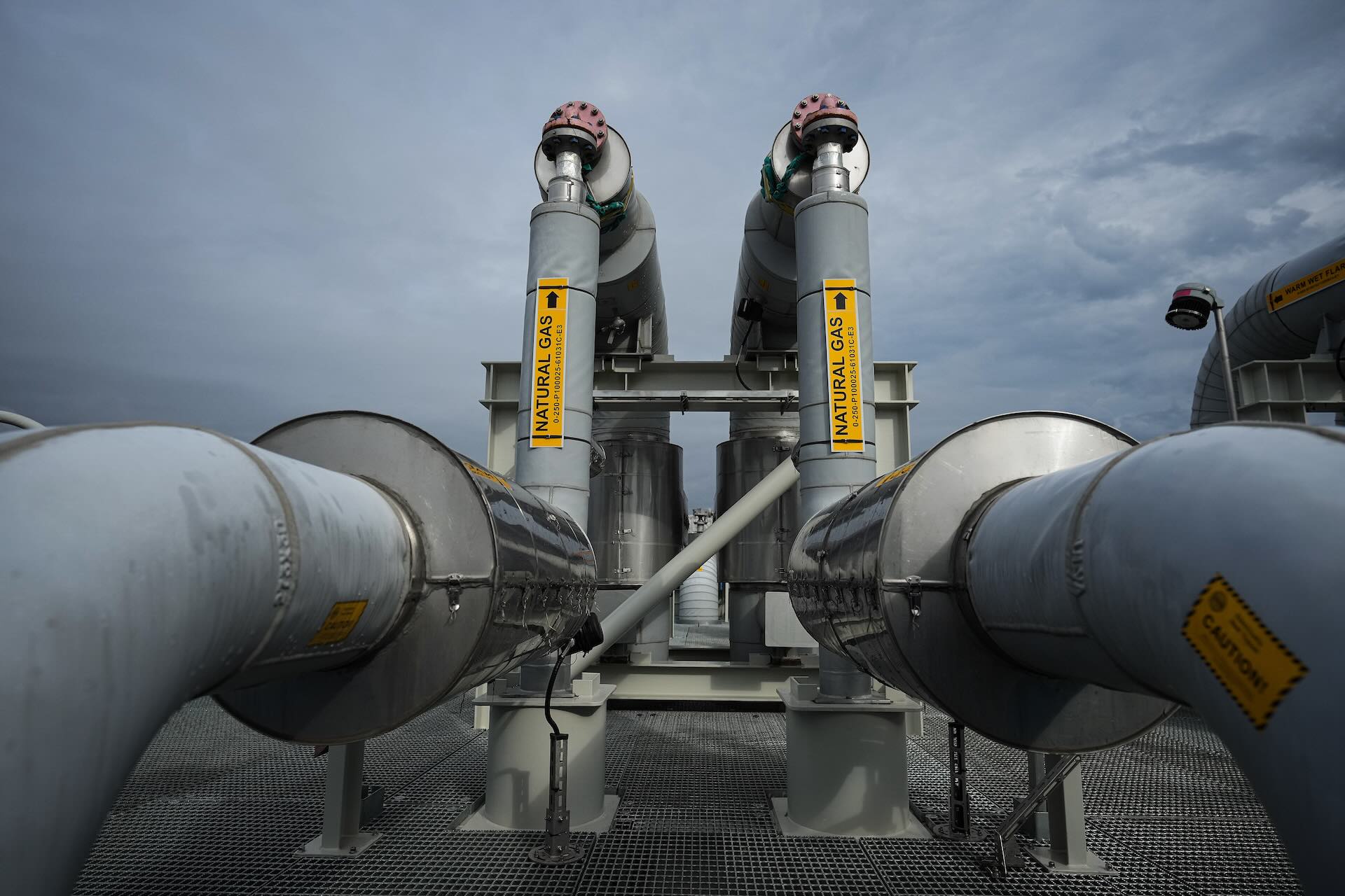 An image of a natural gas terminal against a grey sky.