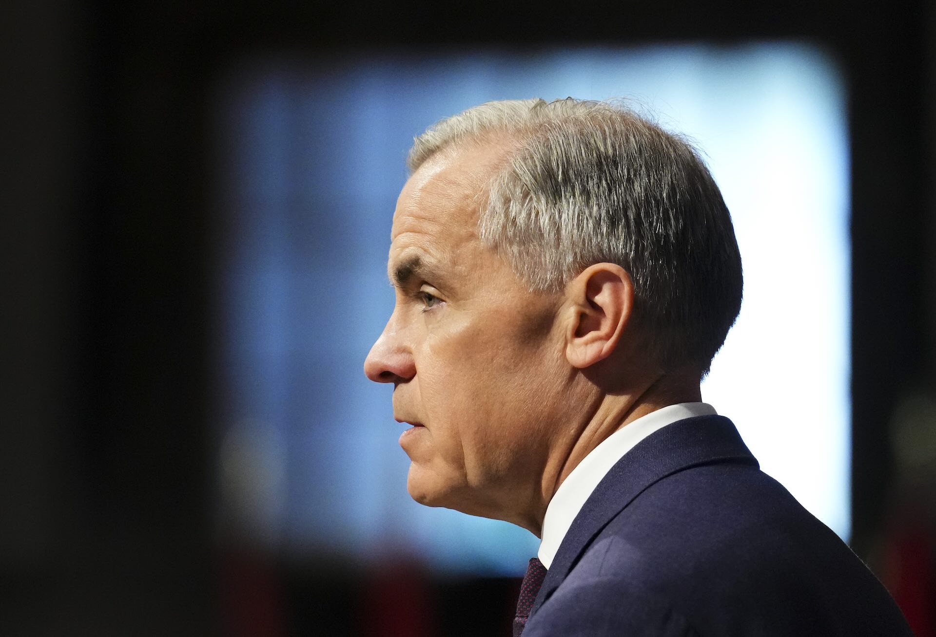 An image of Mark Carney against a light and dark background.