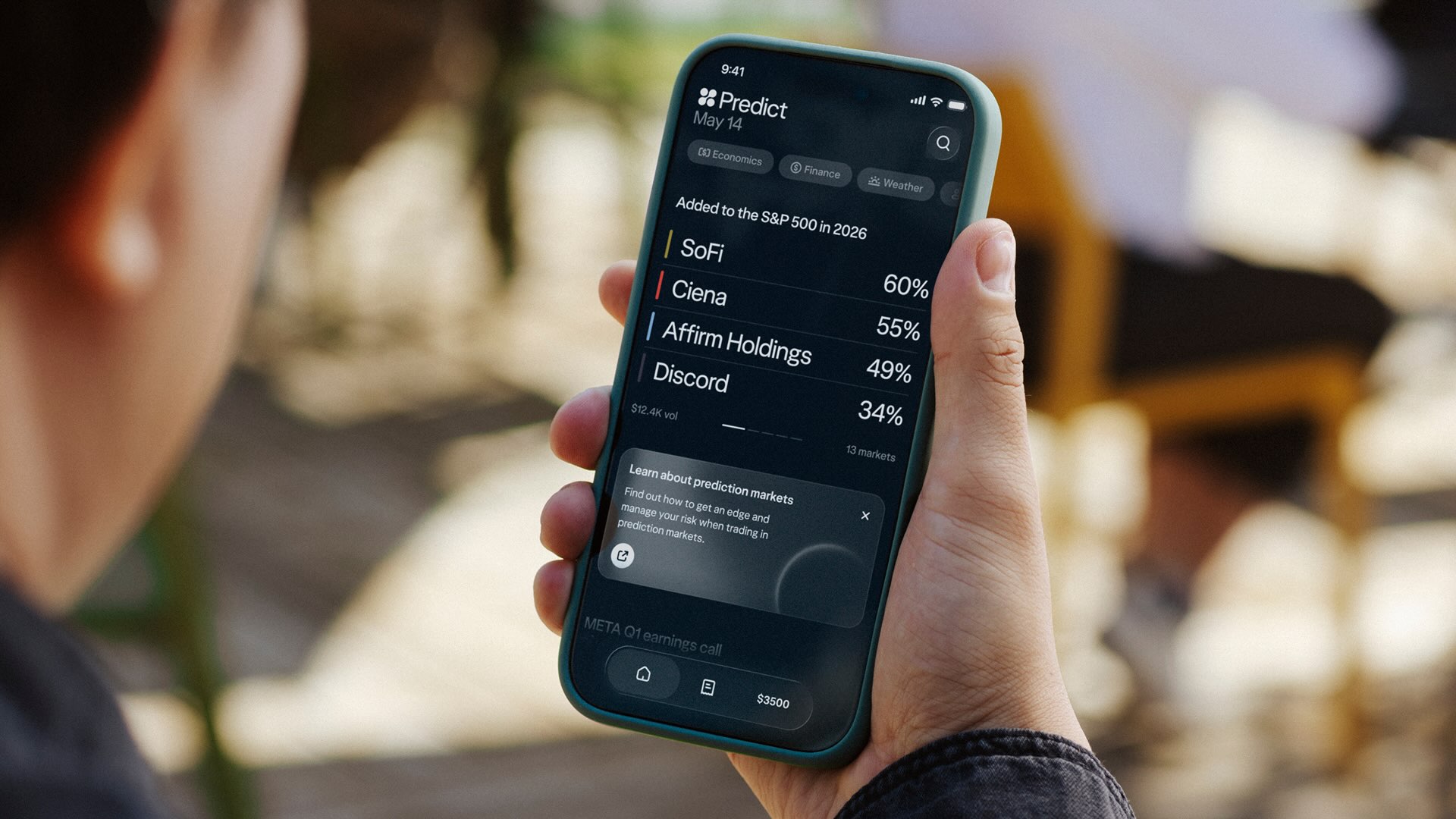 A person holds a smartphone with the Wealthsimple app, which displays various company names, including SoFi, Ciena, Affirm Holdings and Discord, on a dark screen.