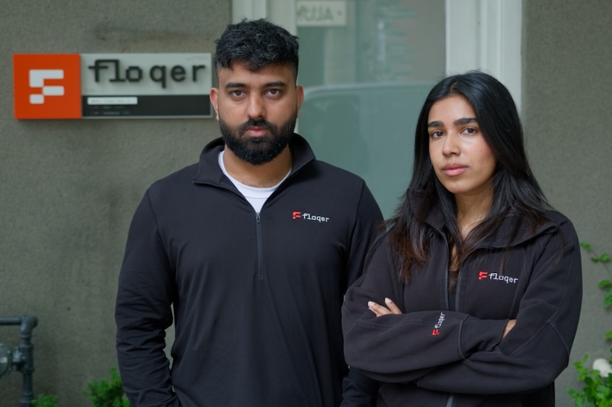 Shivam Mahajan and Zaaheda Islam pose in front of their company offices.