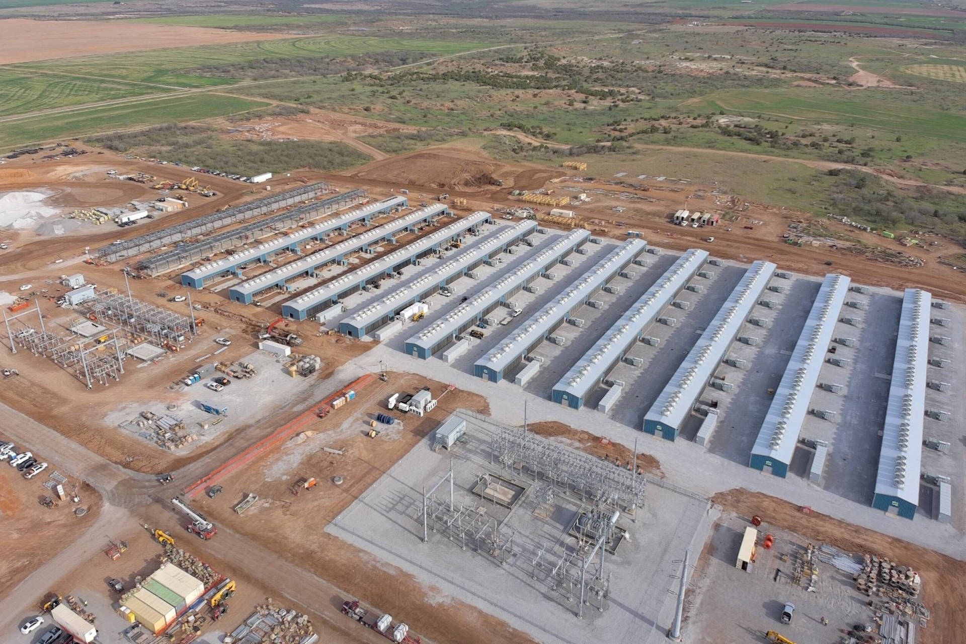 An aerial image of rows of data-centre buildings under construction.