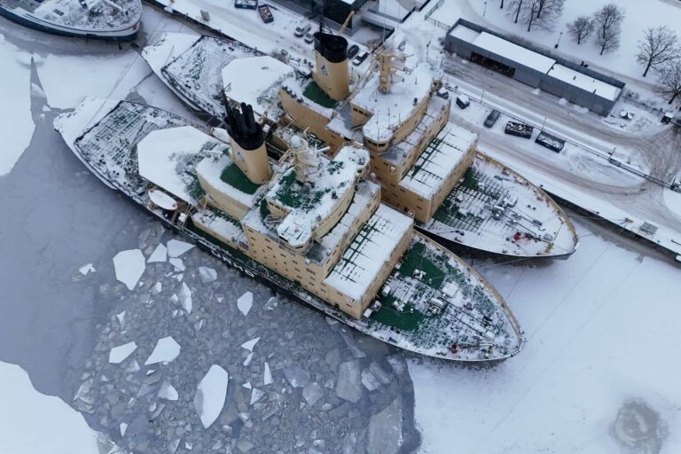An image of two docked icebreakers covered in snow and ice.