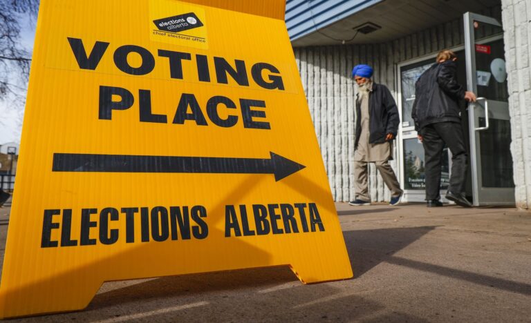 A voter leaves after casting their referendum vote at an advance polling station in Calgary, Tuesday, Oct. 13, 2026.